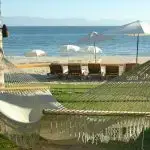A hammock on the grass near the beach